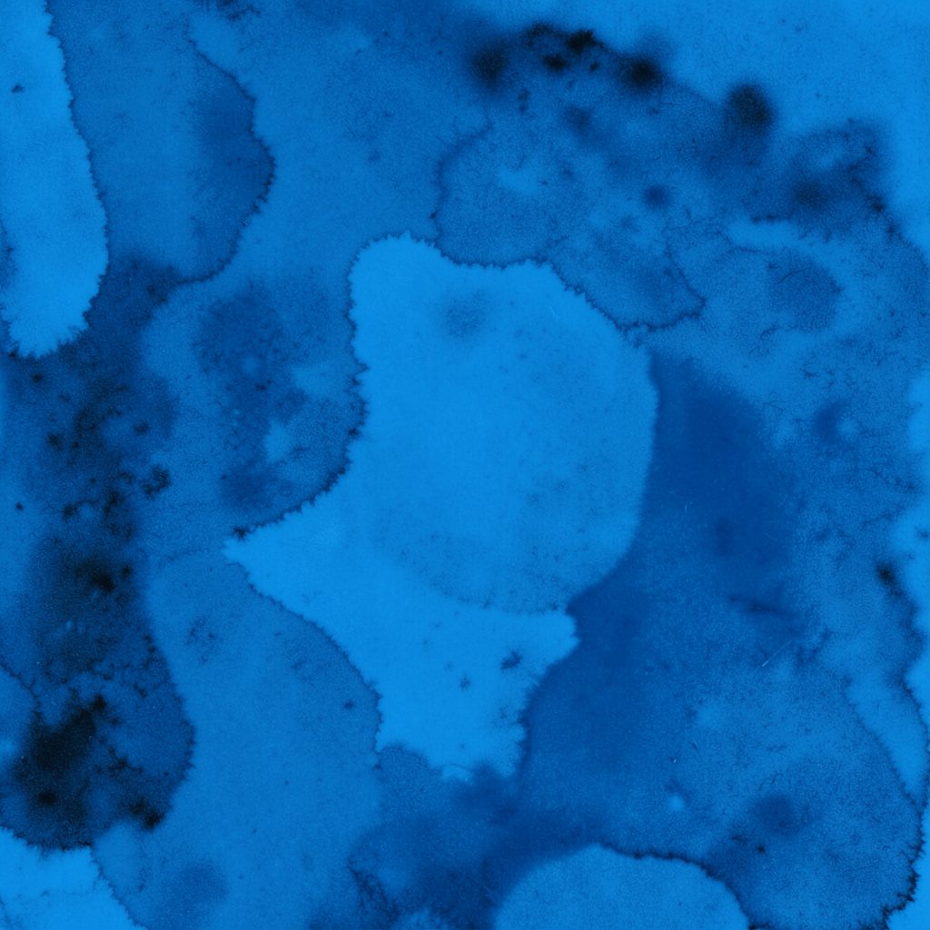 Photographie en duotone bleu et blanc d'un livre ouvert sur une table, ambiance calme et recueillie